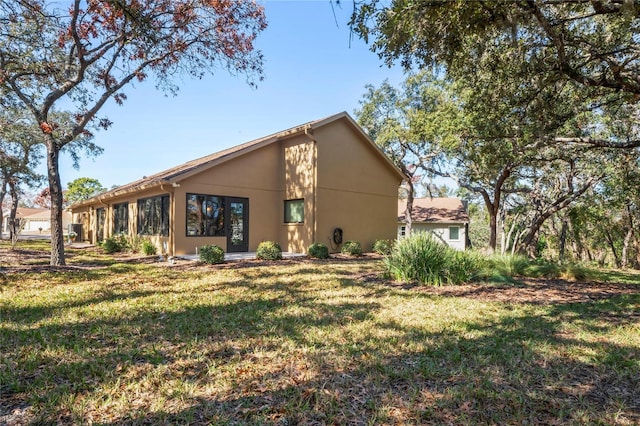 back of house with a lawn