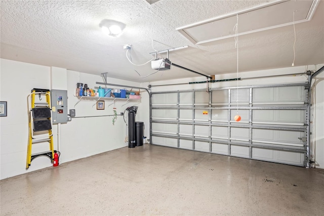 garage featuring a garage door opener and electric panel