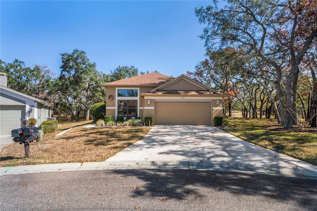 view of front of house with a garage and a front lawn