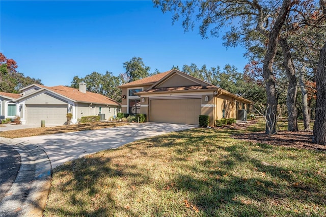 ranch-style house with a garage, central air condition unit, and a front lawn