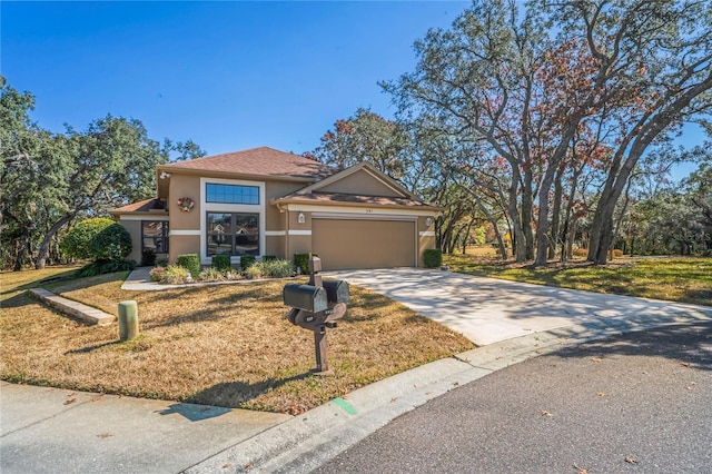 view of front of house with a garage and a front lawn