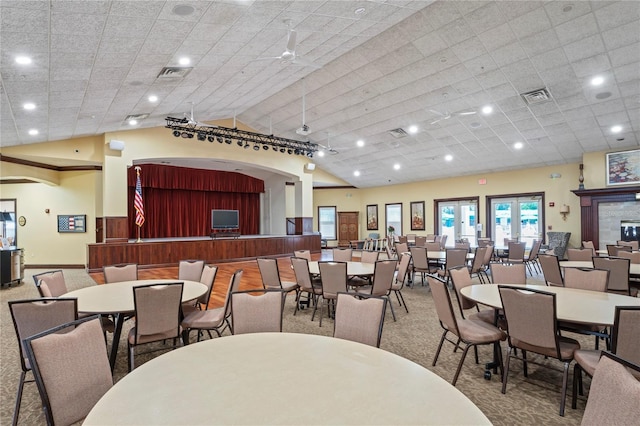 carpeted dining area with lofted ceiling