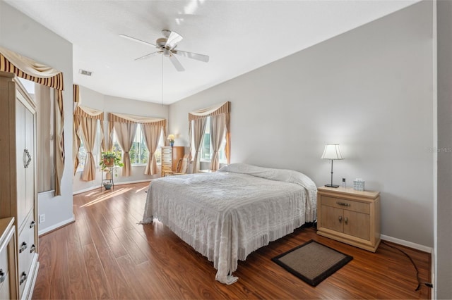 bedroom with dark hardwood / wood-style floors and ceiling fan