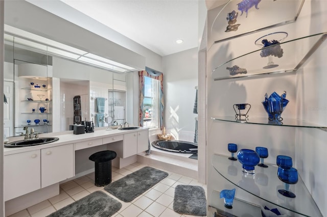 bathroom featuring vanity, tiled tub, and tile patterned floors