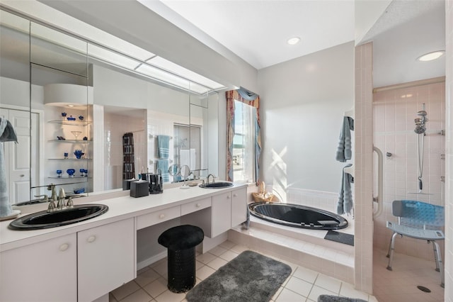 bathroom with tile patterned floors, vanity, and shower with separate bathtub