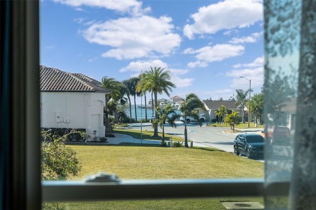 view of community featuring a water view and a yard