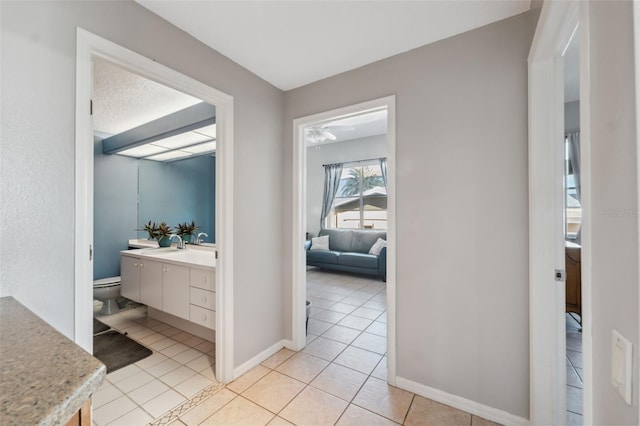 bathroom featuring tile patterned flooring, vanity, and toilet