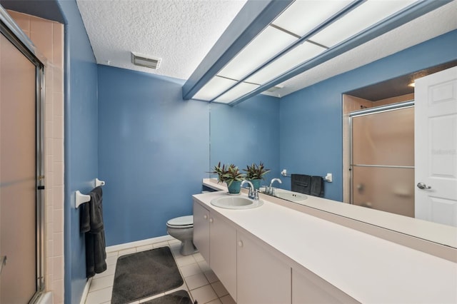 bathroom with toilet, an enclosed shower, a textured ceiling, vanity, and tile patterned flooring