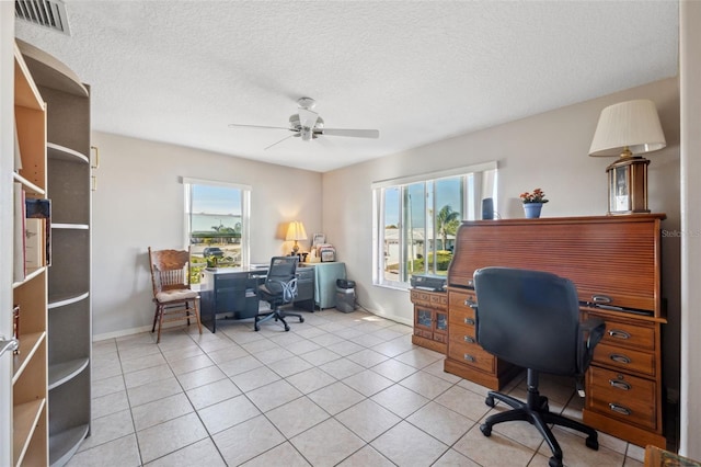 office space featuring light tile patterned floors, a textured ceiling, and ceiling fan