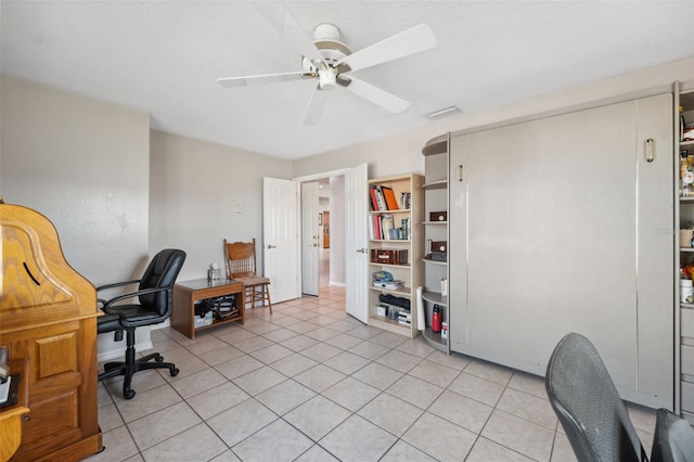 office area featuring a textured ceiling, ceiling fan, and light tile patterned flooring