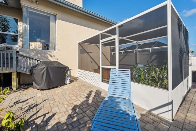 view of patio / terrace featuring a lanai and a grill