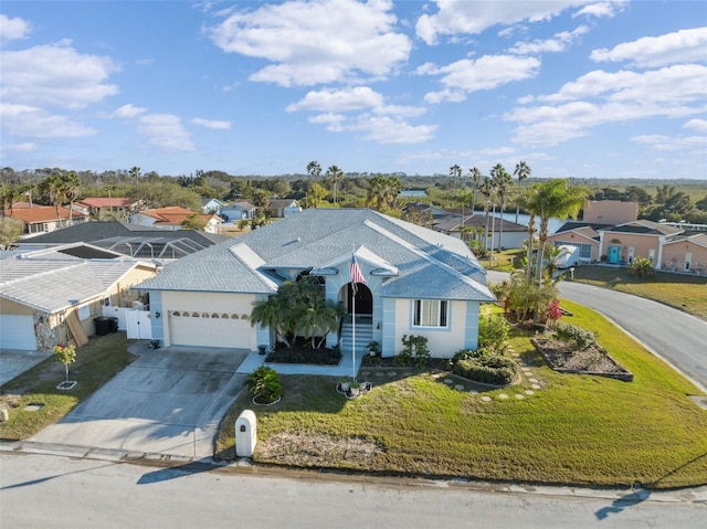 view of front of house with a garage and a front lawn