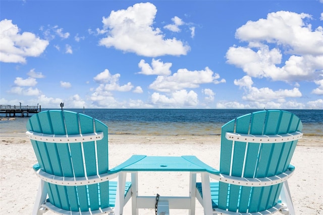 exterior space featuring a water view and a beach view