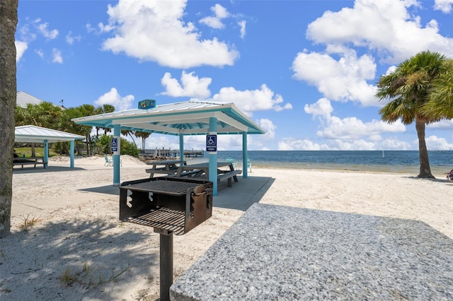 view of property's community featuring a gazebo, a beach view, and a water view