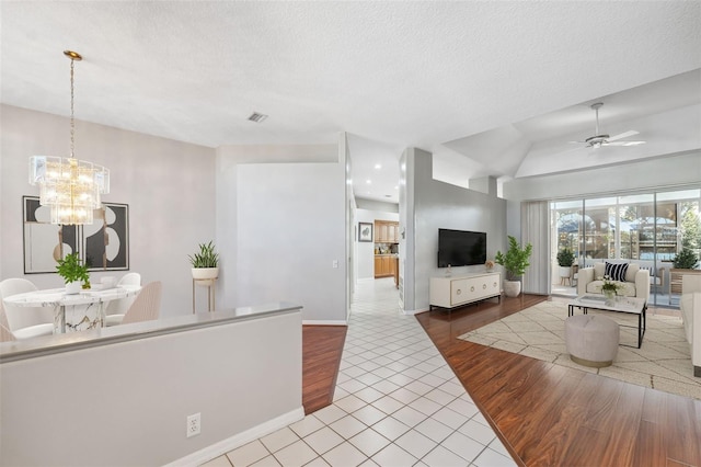 3912 Rudder Way, New Port Richey, FL 34652 - living area with wood finished floors, a ceiling fan, a chandelier, a textured ceiling, and lofted ceiling