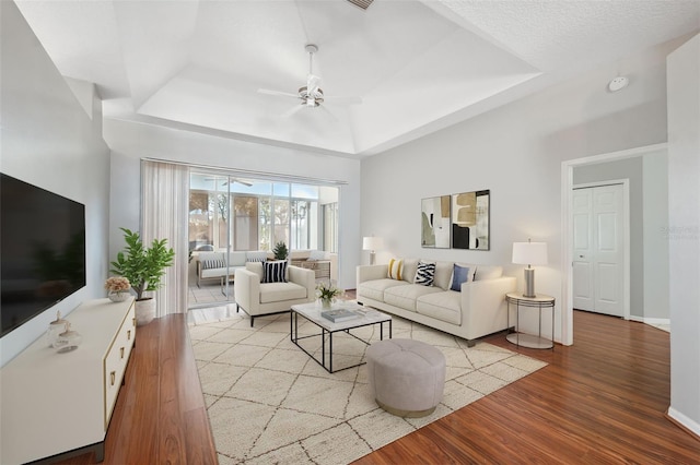 3912 Rudder Way, New Port Richey, FL 34652 - living area with a ceiling fan, a raised ceiling, and wood finished floors
