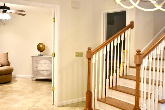 staircase featuring tile patterned flooring and ceiling fan