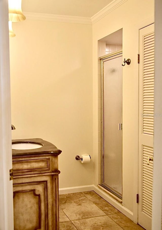 bathroom featuring an enclosed shower, vanity, and ornamental molding