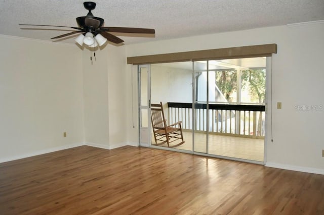 unfurnished room with ceiling fan, hardwood / wood-style flooring, ornamental molding, and a textured ceiling