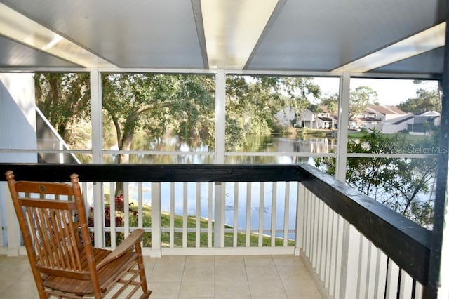 sunroom / solarium featuring a wealth of natural light and a water view