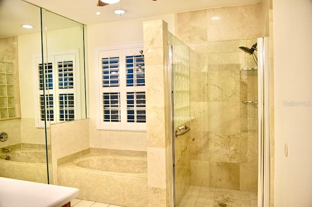 bathroom featuring separate shower and tub and ceiling fan