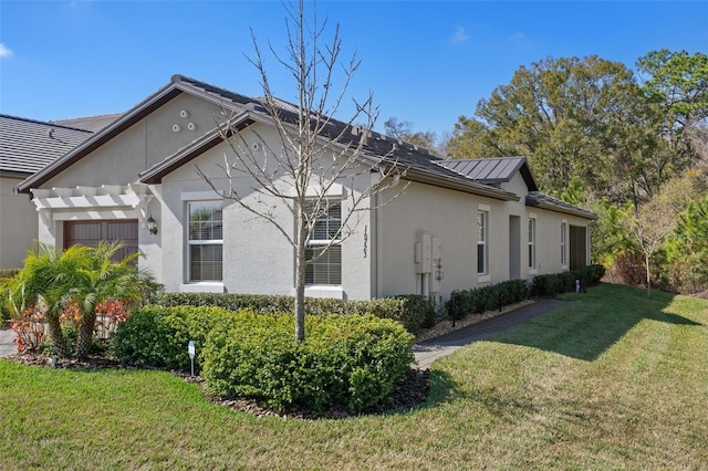 view of side of home with a pergola and a yard