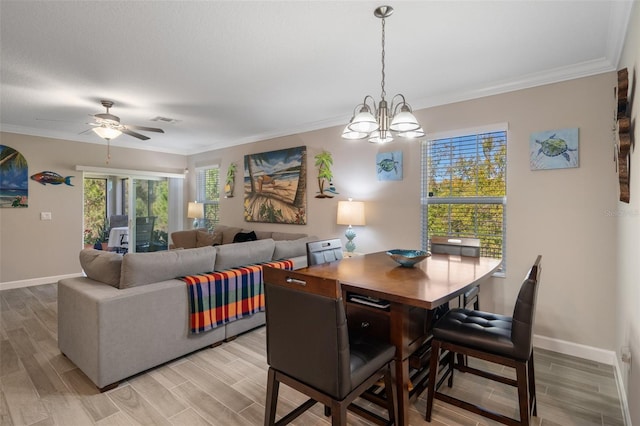 dining space featuring ornamental molding and ceiling fan with notable chandelier