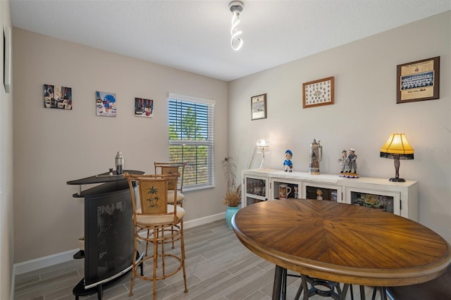 dining space featuring a textured ceiling