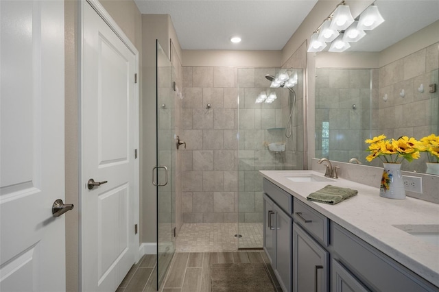 bathroom featuring vanity and an enclosed shower