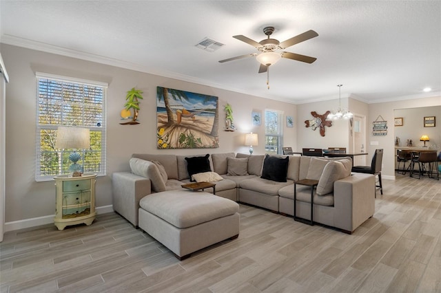 living room featuring crown molding, light hardwood / wood-style flooring, ceiling fan with notable chandelier, and plenty of natural light