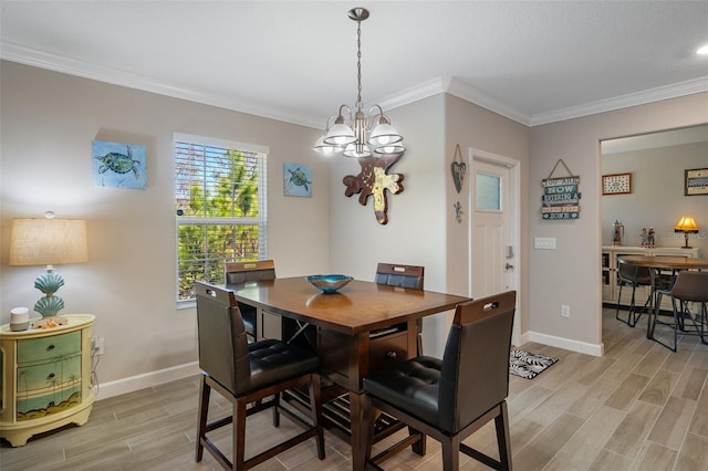 dining room with an inviting chandelier and crown molding