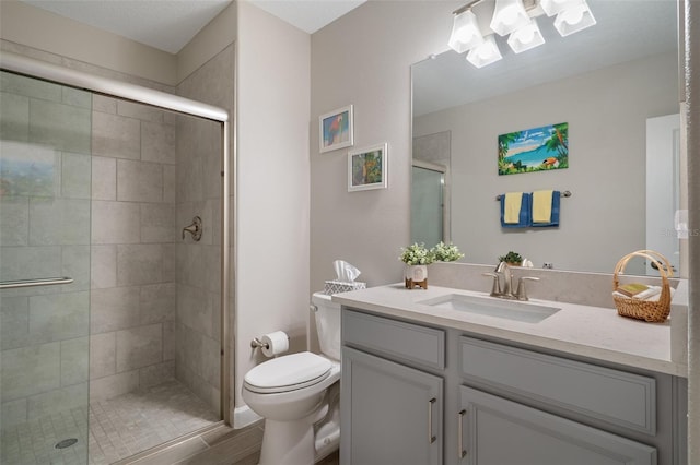 bathroom with walk in shower, vanity, and toilet