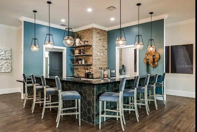 bar with crown molding, dark wood-type flooring, and pendant lighting