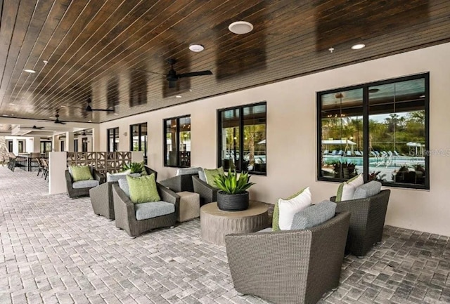 view of patio / terrace featuring ceiling fan and an outdoor living space