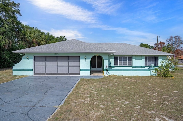 ranch-style home with a garage and a front yard