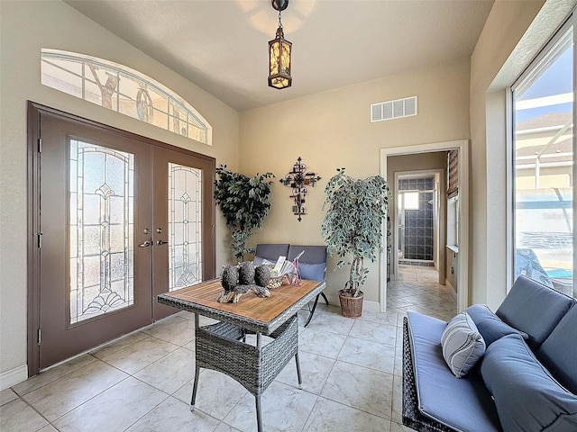 tiled entrance foyer featuring french doors