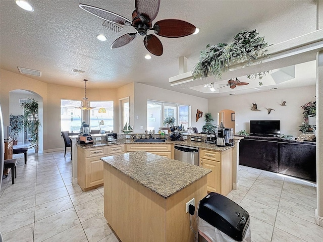 kitchen featuring sink, dishwasher, kitchen peninsula, and a kitchen island