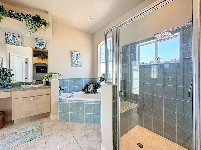 bathroom featuring vanity and separate shower and tub