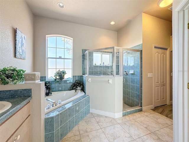 bathroom with vanity and separate shower and tub