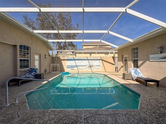 view of swimming pool with a patio and glass enclosure