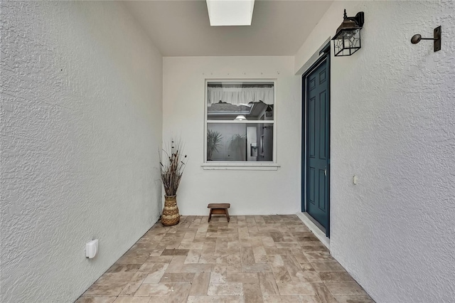 view of exterior entry featuring stucco siding