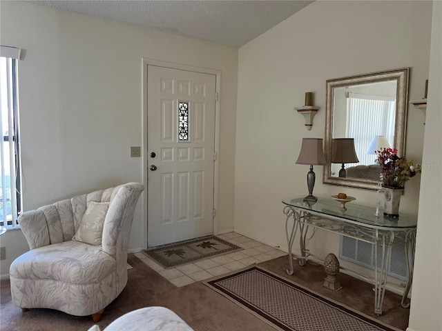 tiled foyer featuring a textured ceiling