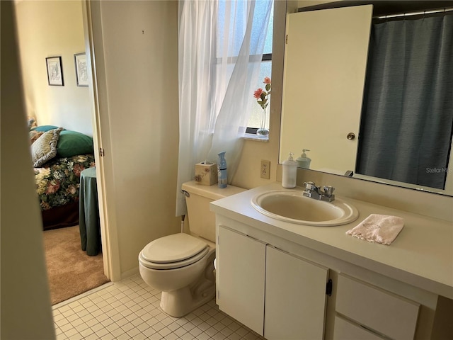 bathroom with vanity, toilet, and tile patterned flooring