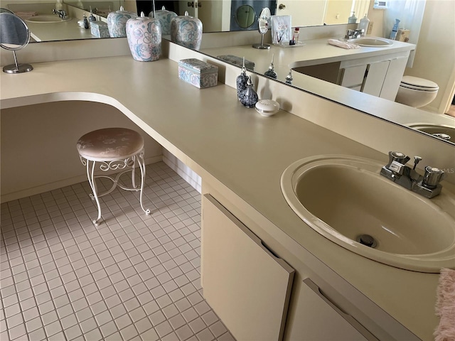 bathroom featuring tile patterned flooring, vanity, and toilet