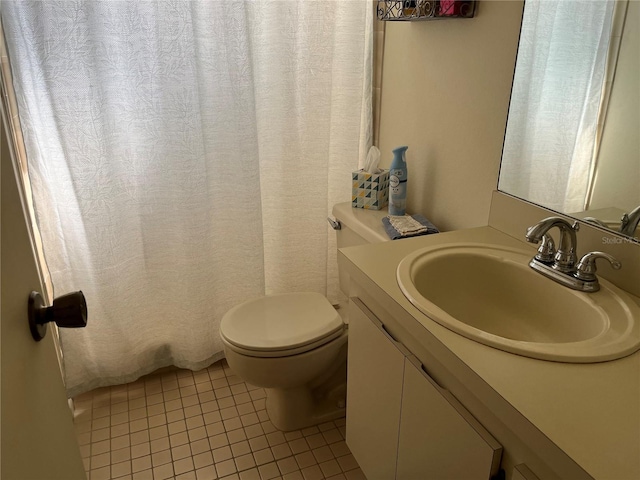 bathroom with vanity, toilet, and tile patterned flooring