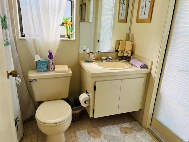 bathroom with vanity, toilet, and tile patterned flooring