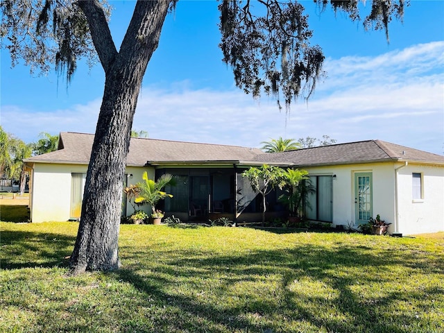 back of property featuring a yard