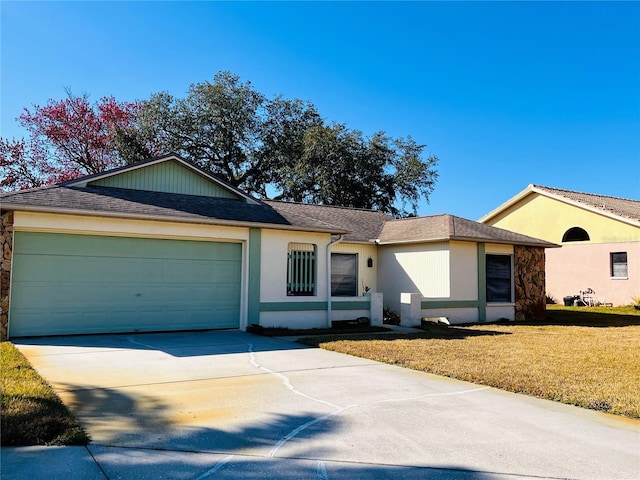 ranch-style home with a garage and a front yard