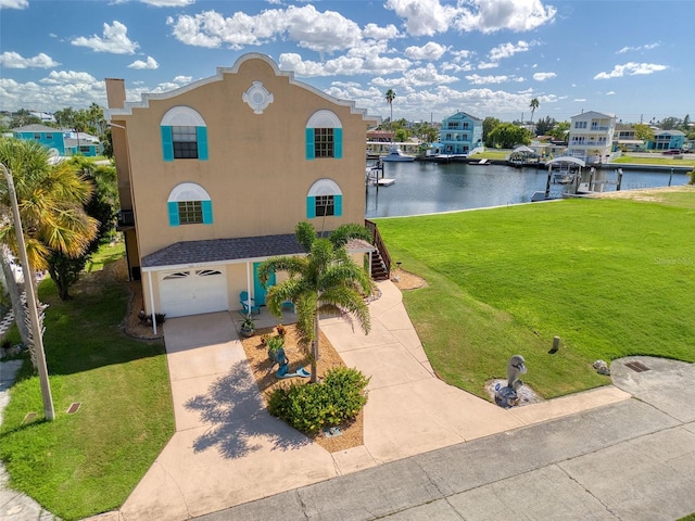 view of front of home featuring a water view, a garage, and a front yard