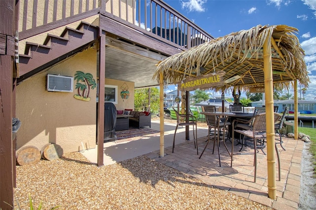 view of patio with an outdoor hangout area and a wall unit AC